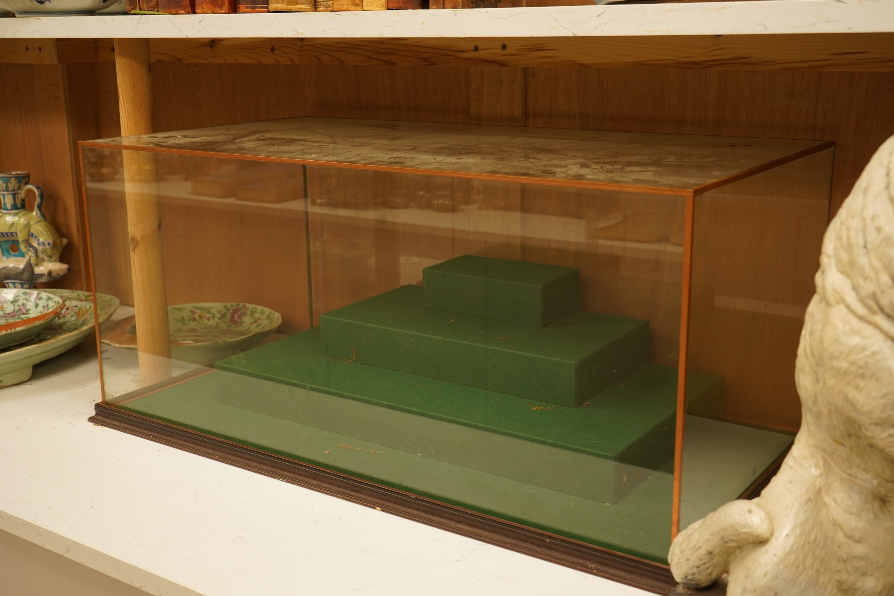 A large table top glass display cabinet with a stepped interior green baize base, 73.5cm wide x 33cm high x 39cm deep